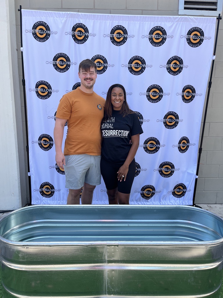 A couple standing beside the baptism tank at Christ Fellowship Tampa