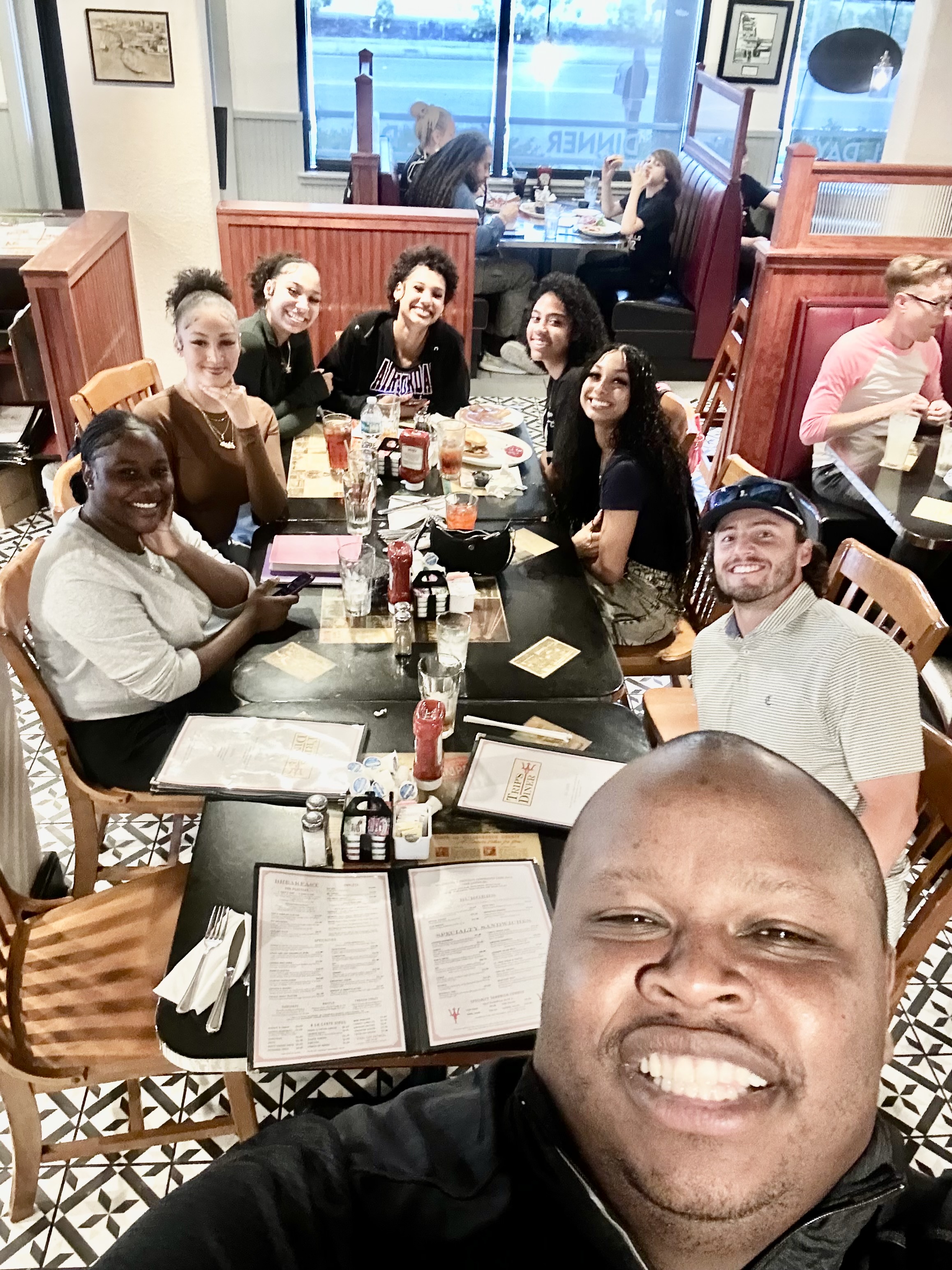 Christ Fellowship Tampa college students and young adults gathered for a meal and smiling together