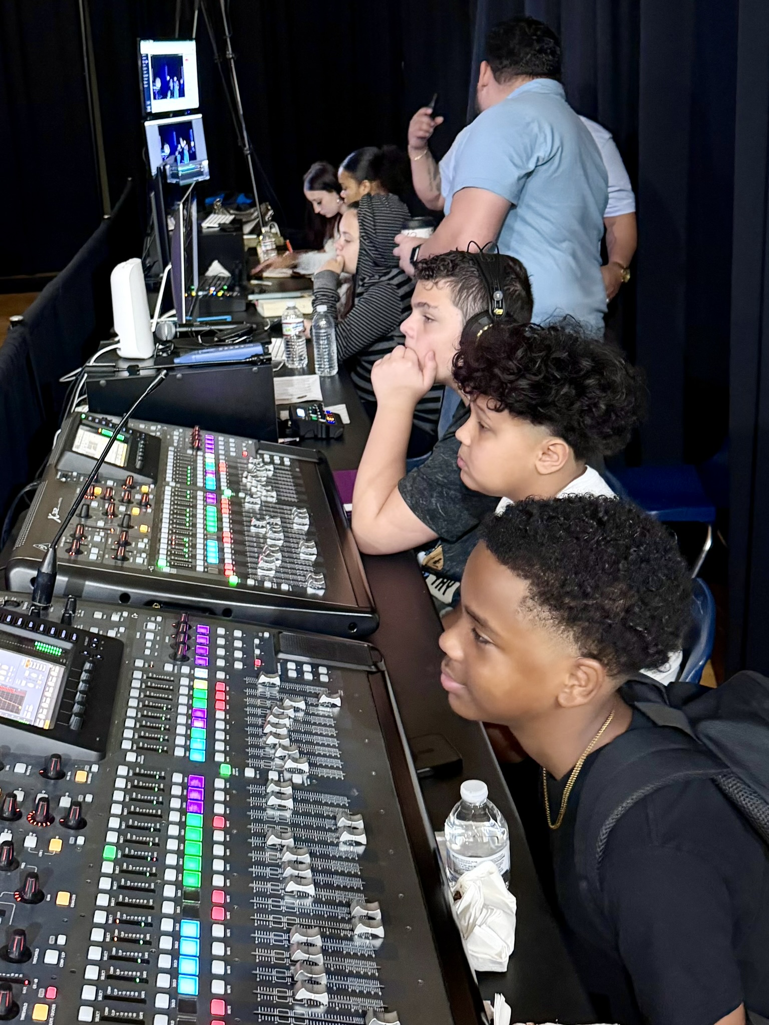 Christ Fellowship teenagers learning to operate the worship audio and video equipment while serving together